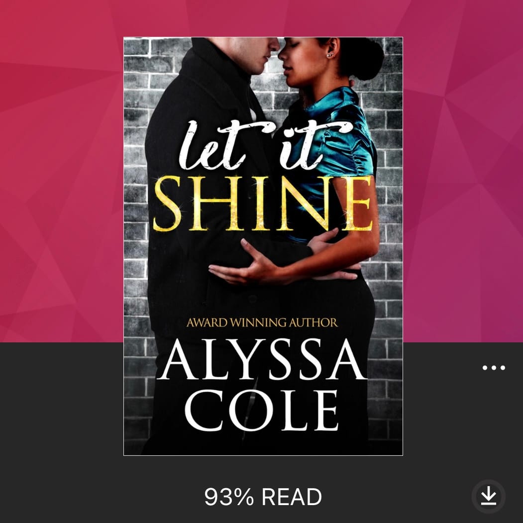 In this audiobook cover image, a Black woman in a blue blouse is standing close to a white man in a dark coat. They are facing each other against a black and white brick wall backdrop, holding each other around the waist and arms. The text at the bottom of the image reads “Let it Shine” by Alyssa Cole. 